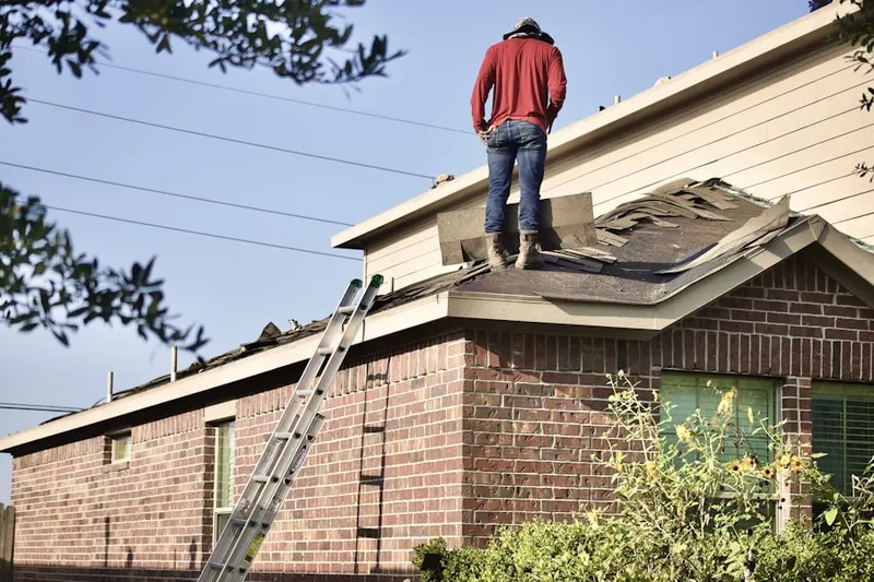 Professional roofer working on a residential roof in Cresson